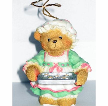 - girl holding a tray of cookies h/ornament