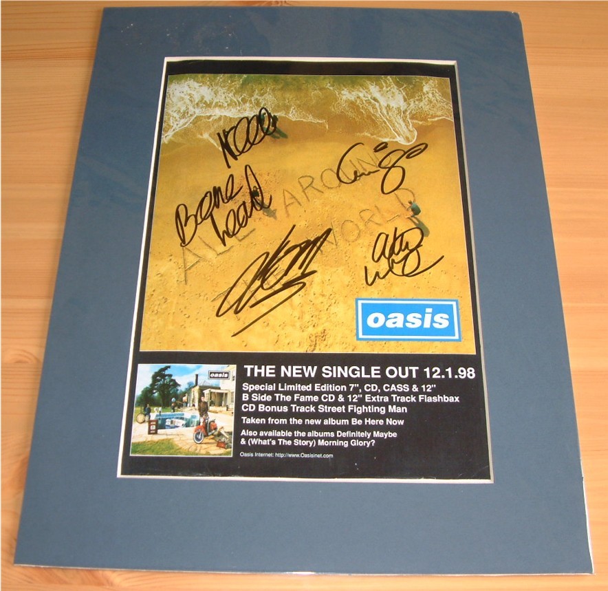 OASIS - GROUP SIGNED & MOUNTED MAG ADVERT PAGE -