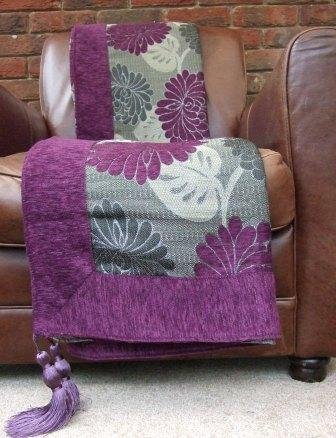 Plum, Damson, Purple Decorative Sofa Throw. This deeply colourfull throw has a contemporary metallic thread running though its central panel which is offset by the soft plain chenille fabric used in t