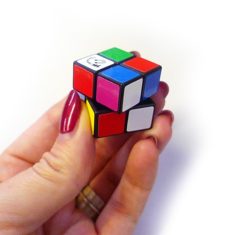 2x2 Cube Puzzle This tiny puzzle cube is a 2 x 2 version of the original Rubiks Cube and will fit much more easily in your pocket or bag! Not only that, once you have conquered the challenge of matching up the colours on each side, the white side can