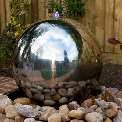 As seen in many designer gardens, the stainless steel sphere is a stunning yet relaxing feature idea