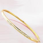 This classic gold bangle features 19 diamonds channel set in 9ct gold. Also available in this style
