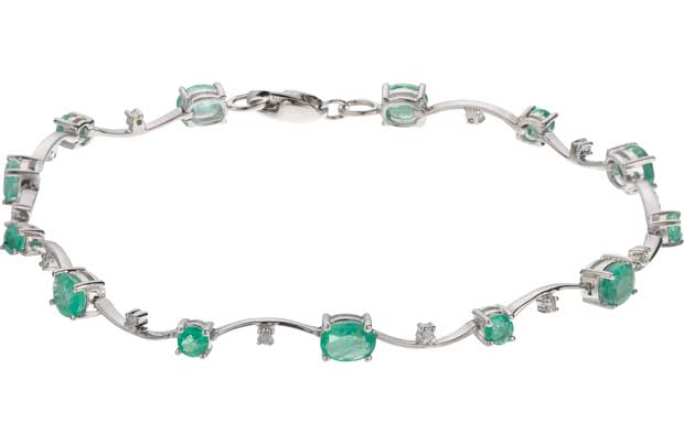 This stunning 9ct white gold bracelet designed with 10 delicately placed diamonds and precious emerald stones makes a gorgeous gift for someone special. The simple