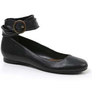 Round toe flat leather pumps featuring bagged wrap around ankle strap with buckle detail. A classic 