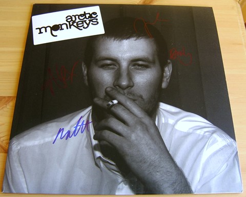 The Arctic Monkeys debut LP ``Whatever People Say I Am  That`s What I`m Not`` signed on the front