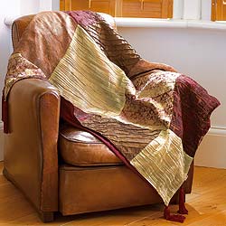 This sumptuous throw recalls the magnificent brocades spun from gold and silver silks, used for