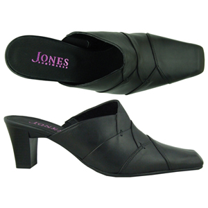 A backless court shoe from Jones Bootmaker. Features square toe, decorative panel work and a small e