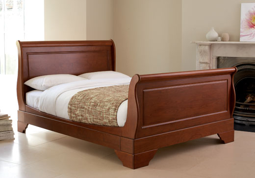 Traditional wooden sleigh bedstead. Beautifully carved solid wooden frame with real cherry wood vene