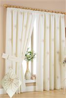 A lined tape top, voile curtain with a pretty floral motif embroidered in delicate neutral shades