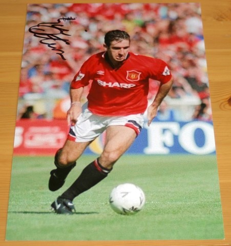 Old Trafford legend Eric Cantona has signed this superb photo in black pen.  COA - 0420000648