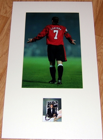 Eric Cantona has signed this small picture of him with the PFA Player of the Year Award in 1994