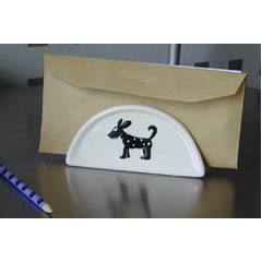 An Italian glazed ceramic napkin holder with dog design.