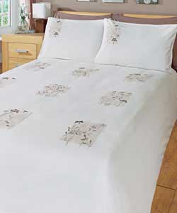 Plain dyed bedding with patchwork design featuring floral detailing with dragonflies.Set contains