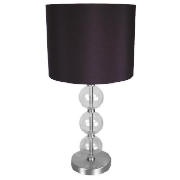 This retro-style chrome table lamp has a clear glass ball design and faux black silk cylinder shade.