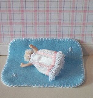 This delightful little 1:12 scale blue baby blanket is handmade exclusively for us by Sally Grice