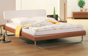 The Hasena Lugo has the following features: Milo legs and Pieve headboard Bed in Cherry and