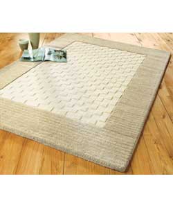 Ivory wool pile rug with natural border cut.Cut and loop style backed rug.Edges bound.Light vacuum