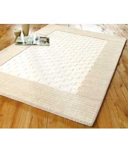 Ivory wool pile rug with natural border cut.Loop s