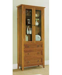 Solid wood with antique pine stain.2 glass doors and 3 drawers with antique effect handles. 4