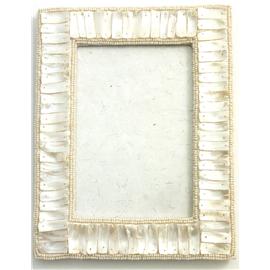 These photo frames are put together and embellished in Delhi. The mother of pearl is handmade. The c