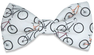 A lovely hand-made silk bow tie featuring mountain bikes in yellow, black and red all over a white b