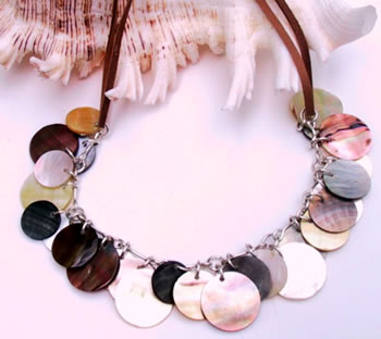 This simply stunning necklace compromises a silver chain decorated with shell discs in an array of