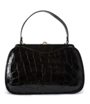 Large, shiny, mock croc bag with frame and clasp design and short handle with gold colout trims. Spa