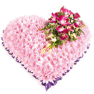 A pretty and feminine massed heart with a spray of Orchids.