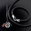 Black plaited leather necklace with solid silver hook fastener. Length: 46 cm (18 ins).