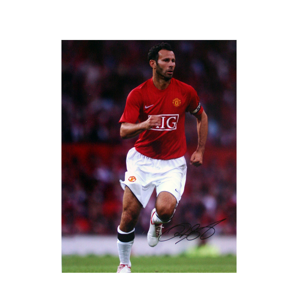 This signed Ryan Giggs photograph shows Giggs in action for Manchester United.The print is 16` x 12`