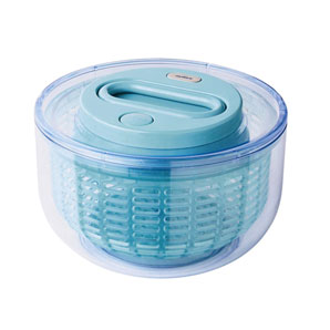 A fast-moving aqua acrylic salad spinner with a transparent outer case and stop button. The