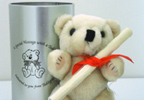 Lift the lid on the silver tin and you will find a jointed teddy bear with the cutest little face