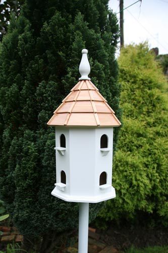 This bird house is a large dovecote house. It stands on a 1.52m wood pole and has a cedar roof