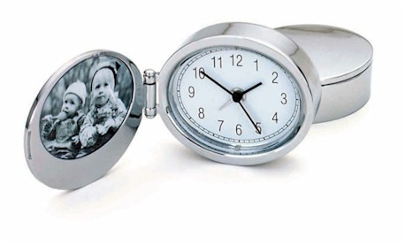 Unique and stylish travel alarm clock incorporates oval picture frame in a compact package - a