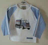 White top with blue truck print on the front and "