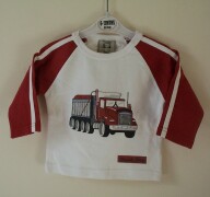 White top with red truck print on the front and "T
