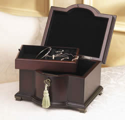 Our mahogany veneered bow-fronted casket has a felt-lined interior with ring rolls and compartments