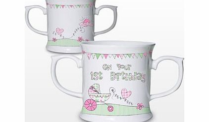 Your childs first birthday is a special occasion so why notcelebrate with this cute Whimsical Pram 1st Birthday Mug?The white ceramic mughas two handles which will help yourchildto hold and learn to drink from a mug  features a gorgeouspink  gre