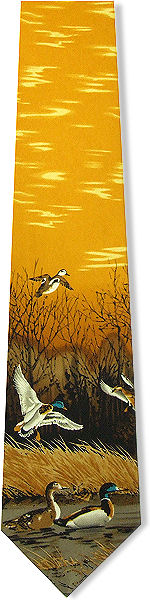 A lovely gold tie with a floating and flying ducks scene at the bottom.